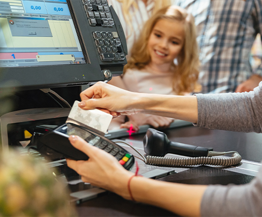 Store owner confidently using a Touch POS system at the counter